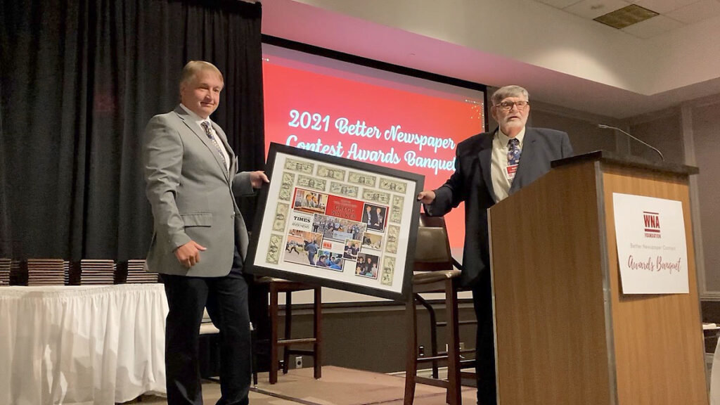 Pat Reilly (right) presents outgoing WNA president Gregg Walker with a traditional Buck Board during the WNA Better Newspaper Contest Awards Ceremony on Friday, June 24, at the Madison Concourse Hotel and Governors Club in downtown Madison. (Photo by Julia Hunter / WNA)